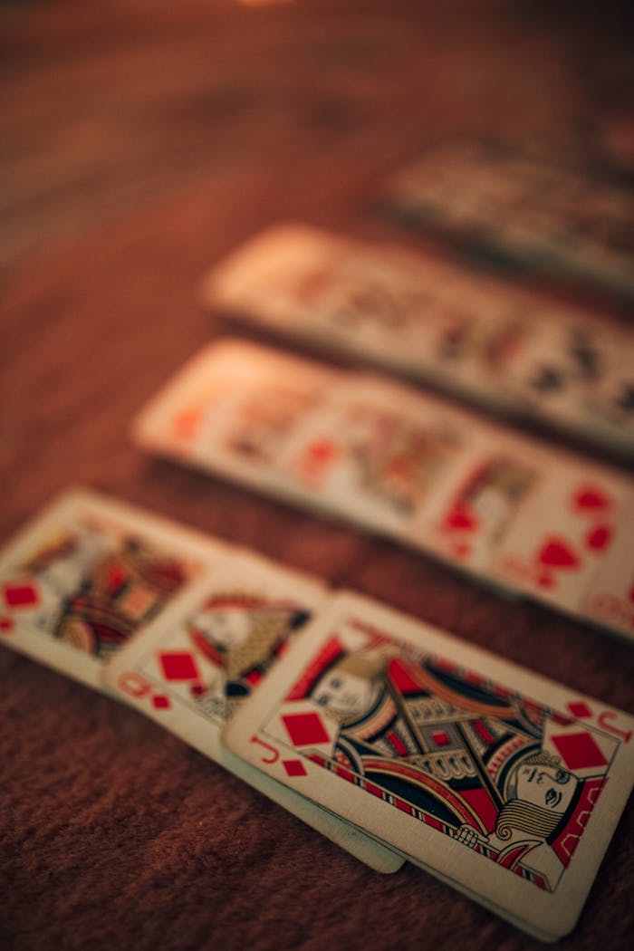 Close-up view of playing cards with a shallow depth of field, featuring a warm and artistic ambiance.